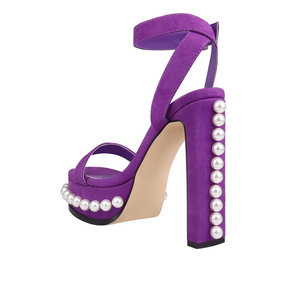 Women's heels in purple color with an open toe and a beaded pattern on the bottom-posterior view