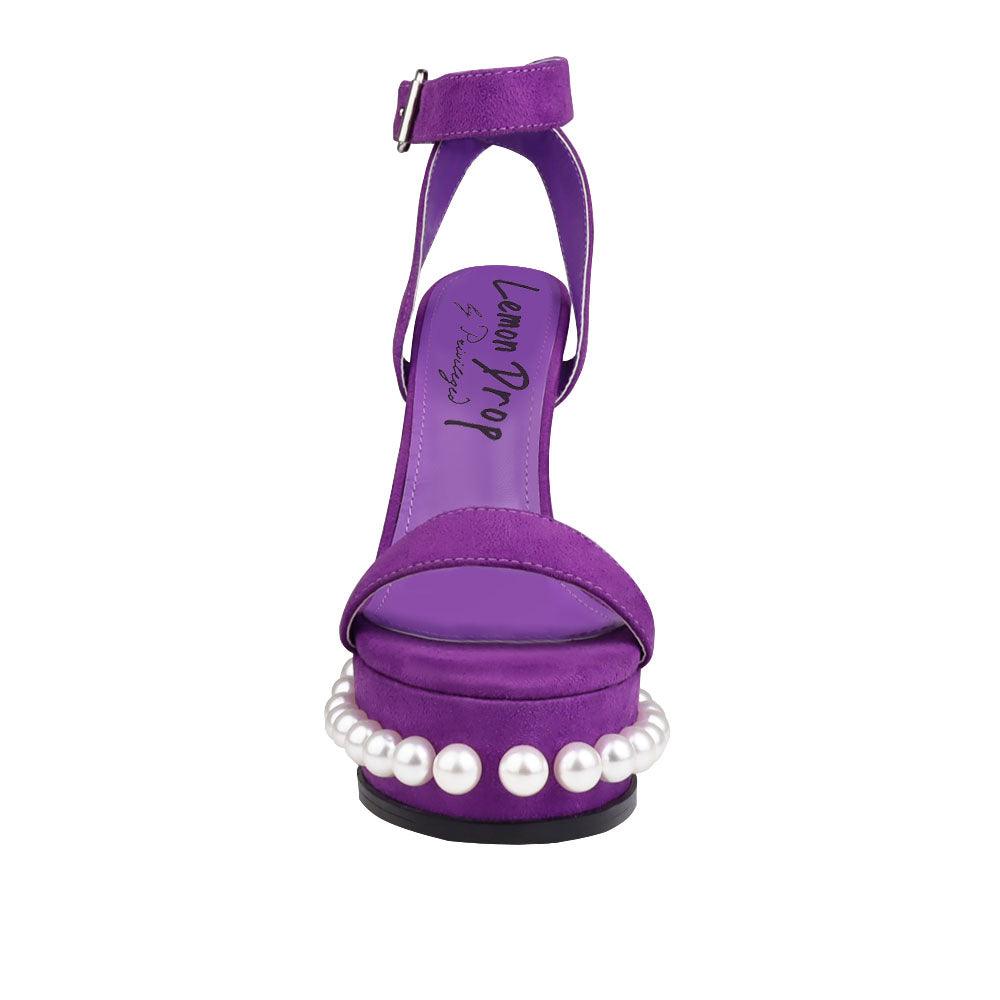 Women's heels in purple color with an open toe and a beaded pattern on the bottom-front view