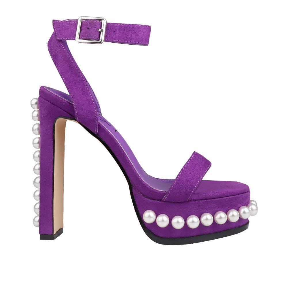 Women's heels in purple color with an open toe and a beaded pattern on the bottom-side view