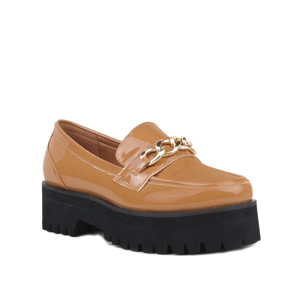 Women's tan-colored leather shoes with metal chain and thick black bottom-corner view