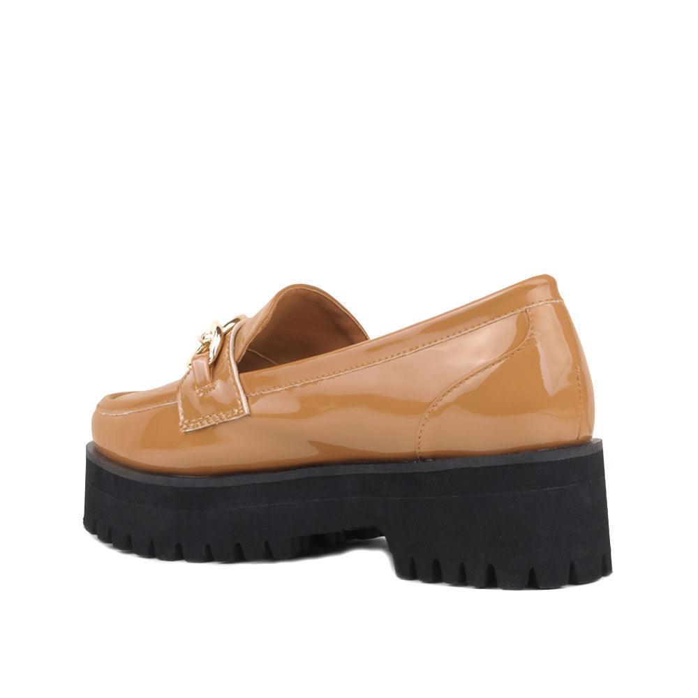 Women's tan-colored leather shoes with metal chain and thick black bottom-posterior view