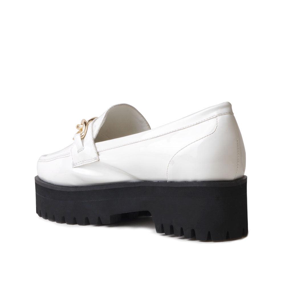 White leather women's shoes with metal chain and thick black bottom-posterior view