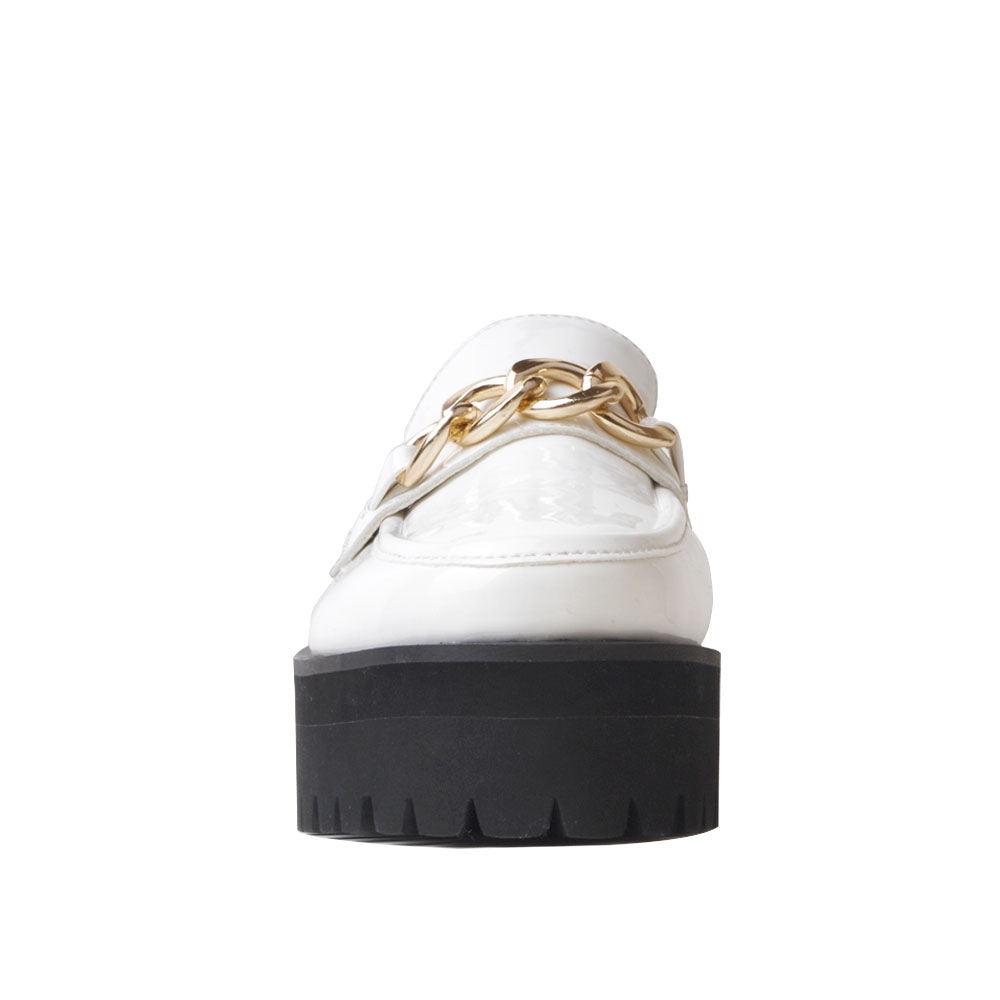 White leather women's shoes with metal chain and thick black bottom-front view