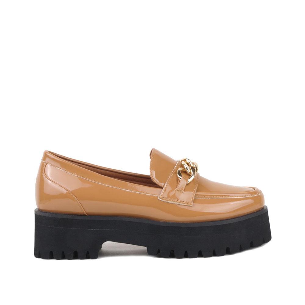 Women's tan-colored leather shoes with metal chain and thick black bottom-side view