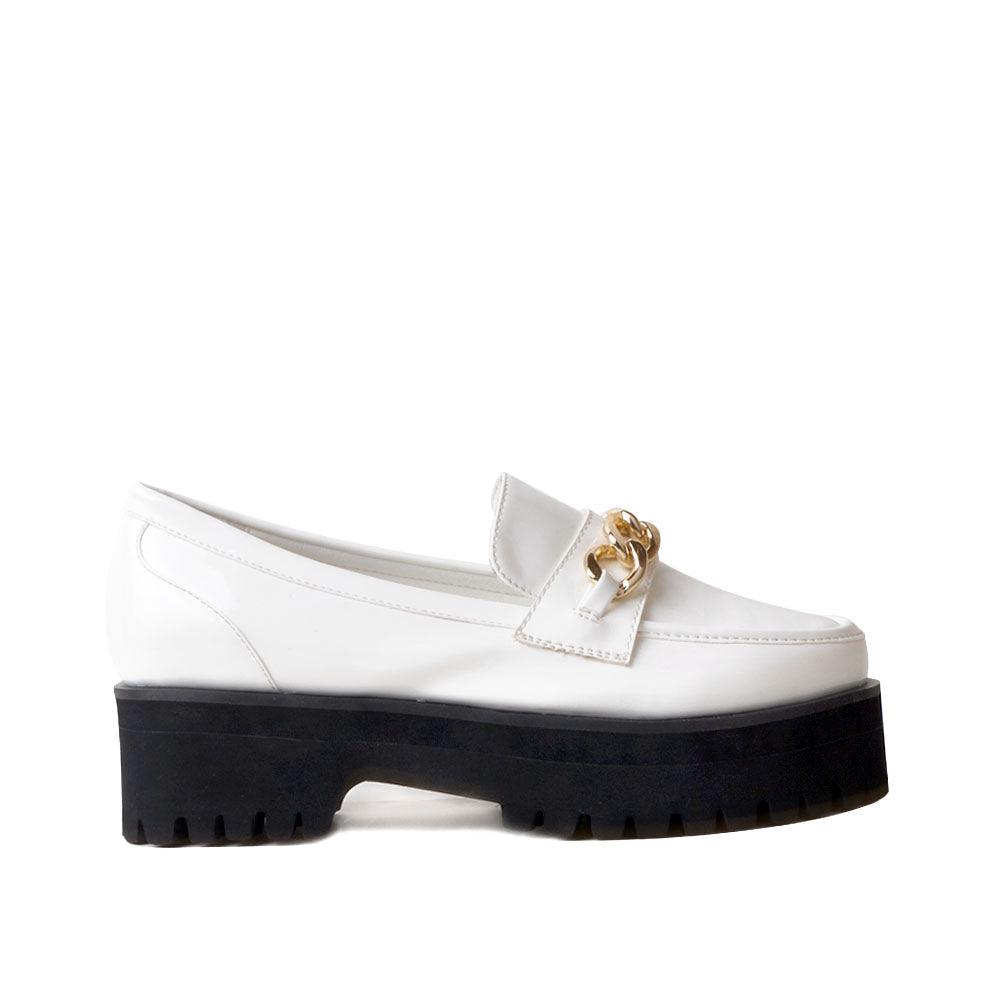 White leather women's shoes with metal chain and thick black bottom-side view