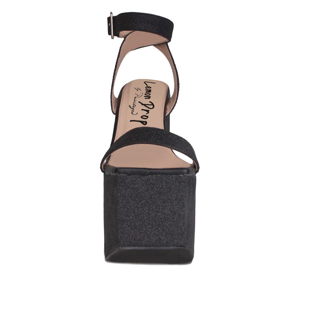 Women's platform shoes in black colored with a sandal buckle-front view