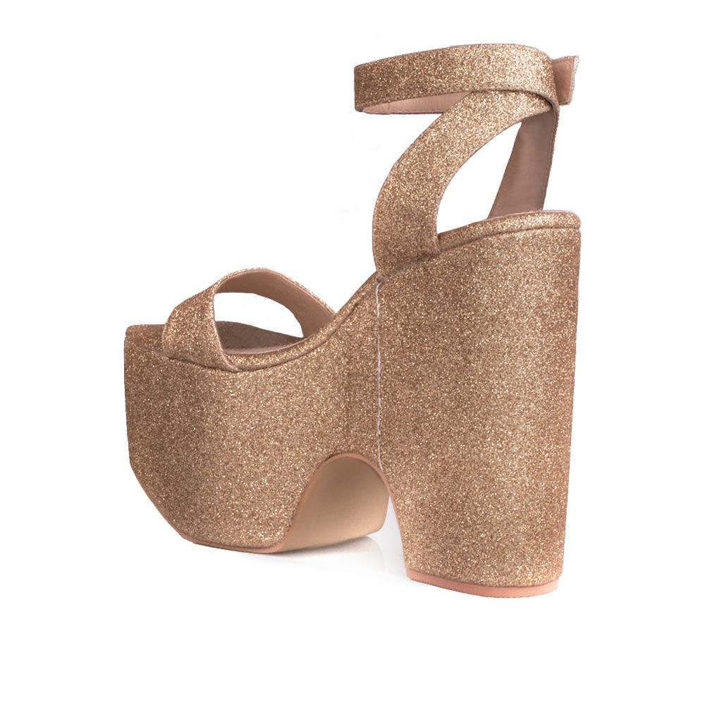 Women's golden platform shoes with a sandal buckle-posterior view