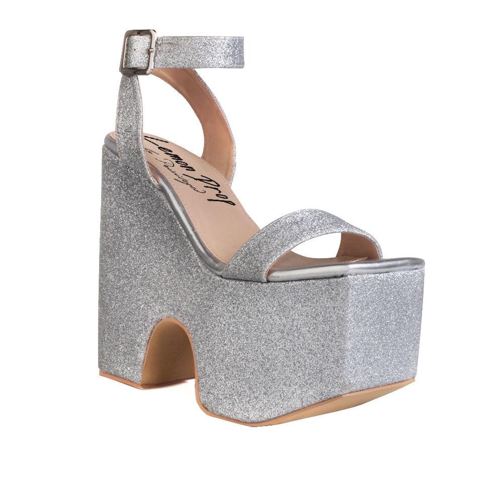 Women's silver colored platform shoes with sandal buckle-corner view