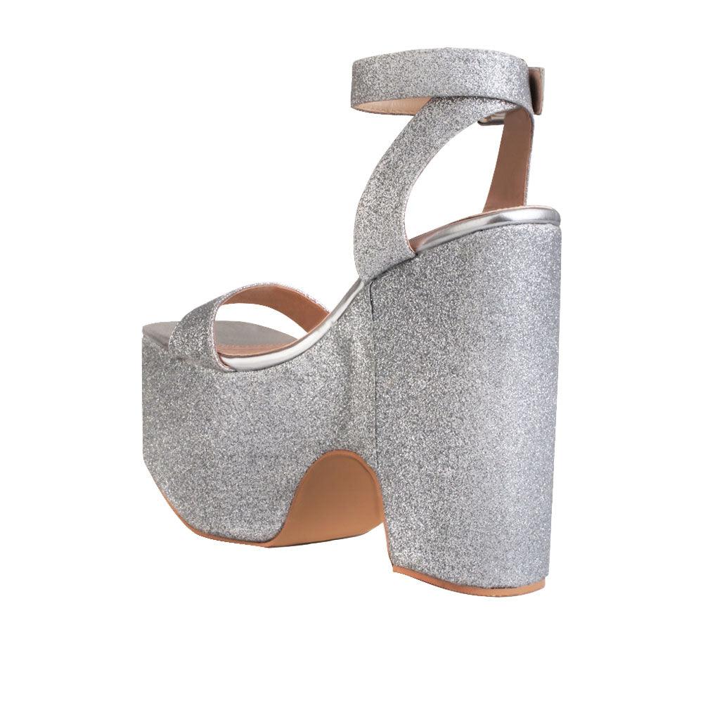 Women's silver colored platform shoes with sandal buckle-posterior view