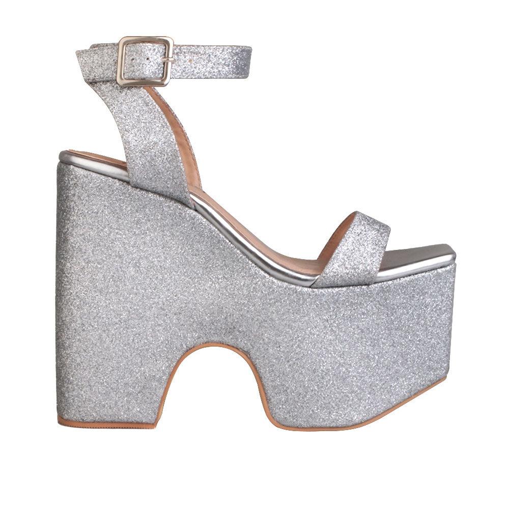 Women's silver colored platform shoes with sandal buckle-side view