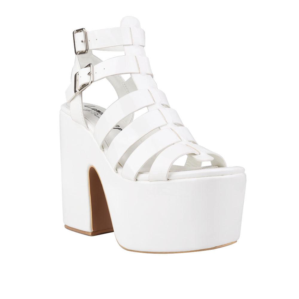 Women's white-colored wedge block heels with a double sandal buckle and strap design - corner view