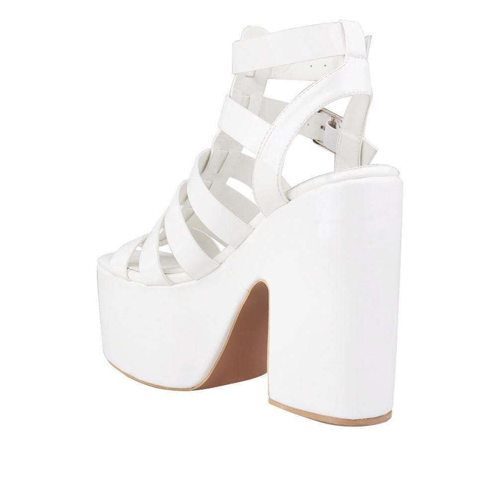 Women's white-colored wedge block heels with a double sandal buckle and strap design - posterior view