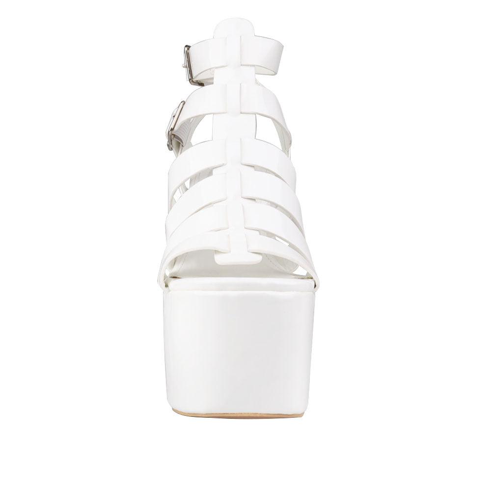 Women's white-colored wedge block heels with a double sandal buckle and strap design - front view