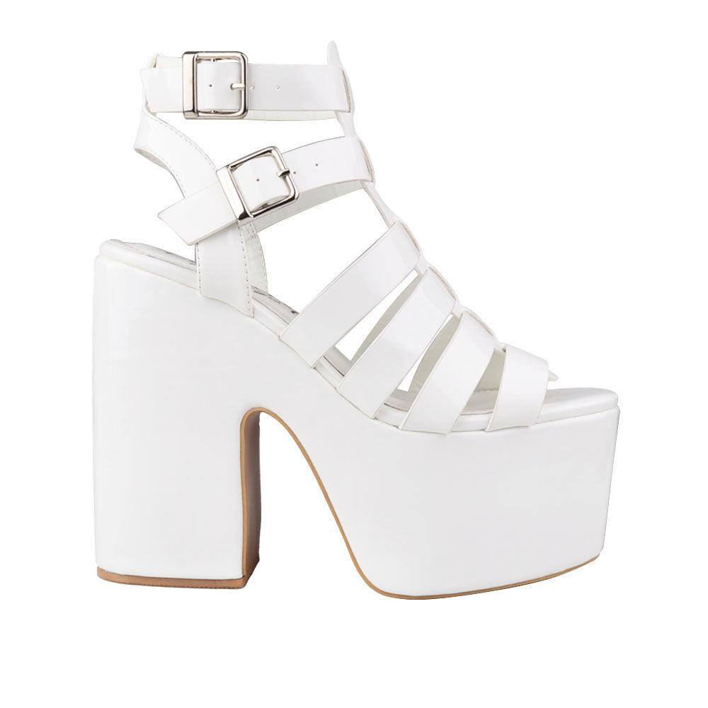 Women's white-colored wedge block heels with a double sandal buckle and strap design - side view