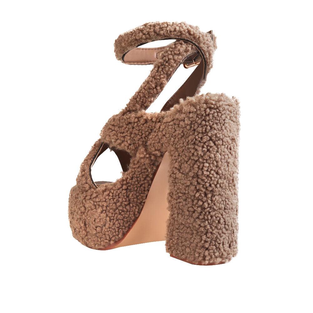 Brown-colored shearling upper platform crossed strap block heels with ankle buckle closure-posterior view