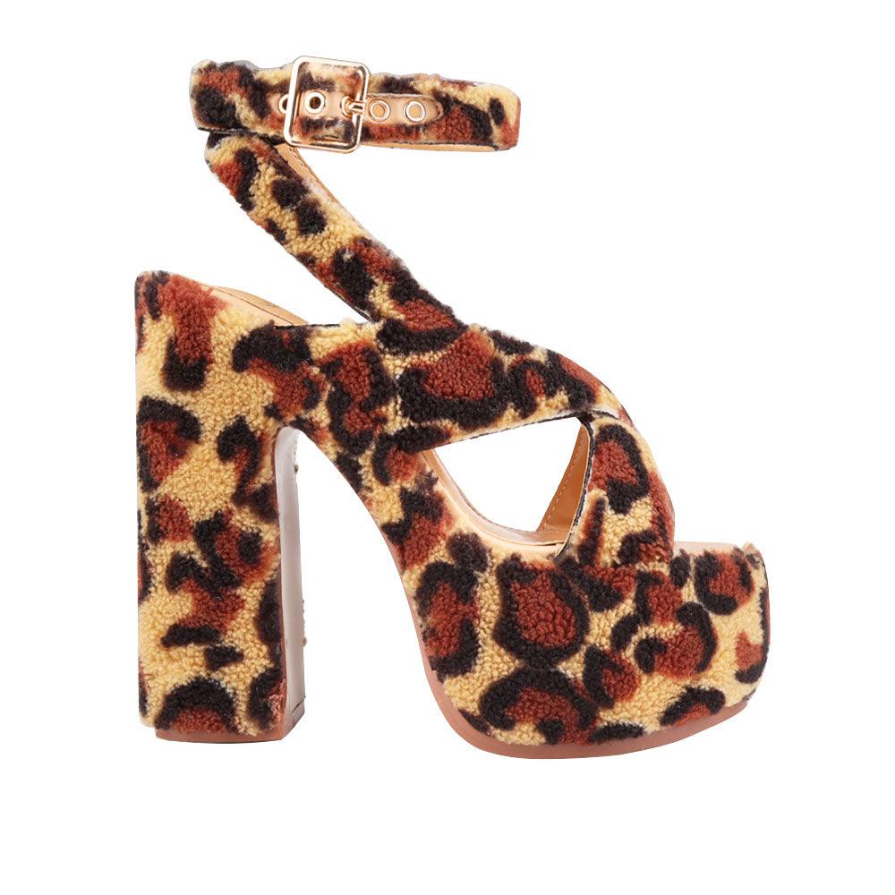 Upper platform crossed strap block heels with ankle buckle closure in leopard patterned shearling-side view