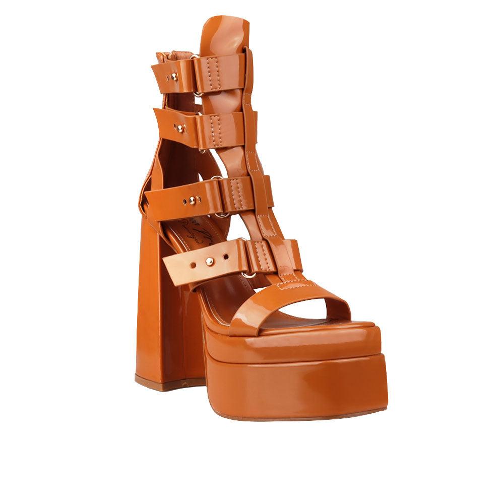 Camel-colored ladies' platform heels with ornate buckle straps and ankle buckle clasp-corner view