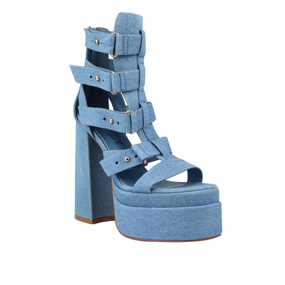 Denim-colored women's platform shoe heels with decorative buckle straps and back zipper-corner view