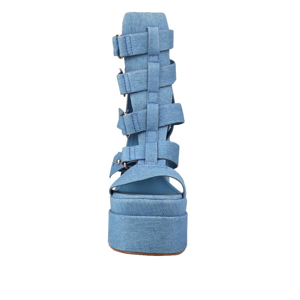 Denim-colored women's platform shoe heels with decorative buckle straps and back zipper-front view