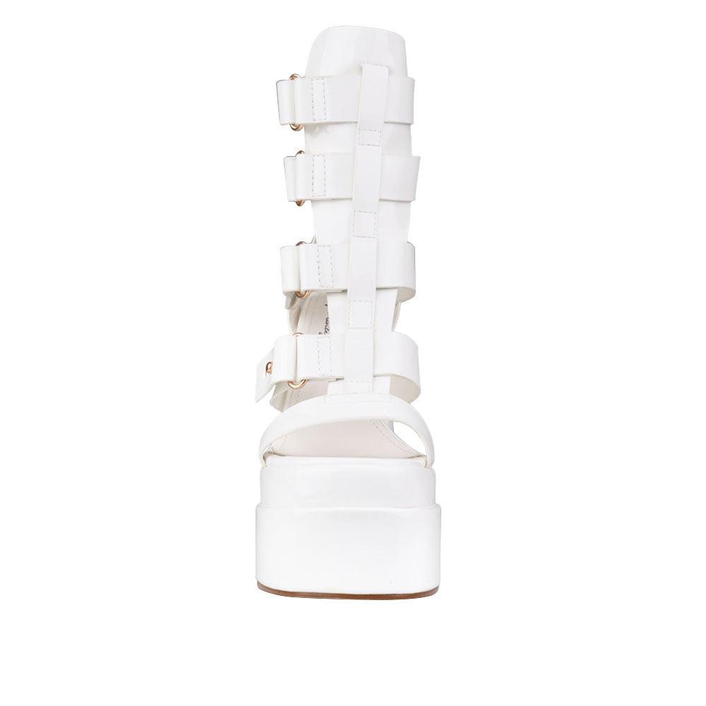 white-colored platform heels for ladies with ornamental buckle straps and ankle buckle clasp-front view