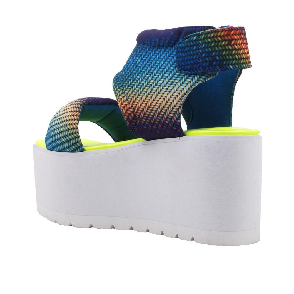 Women's platform shoes with a blue-yellow pattern on the upper, a velcro clasp, and a white bottom-posterior view