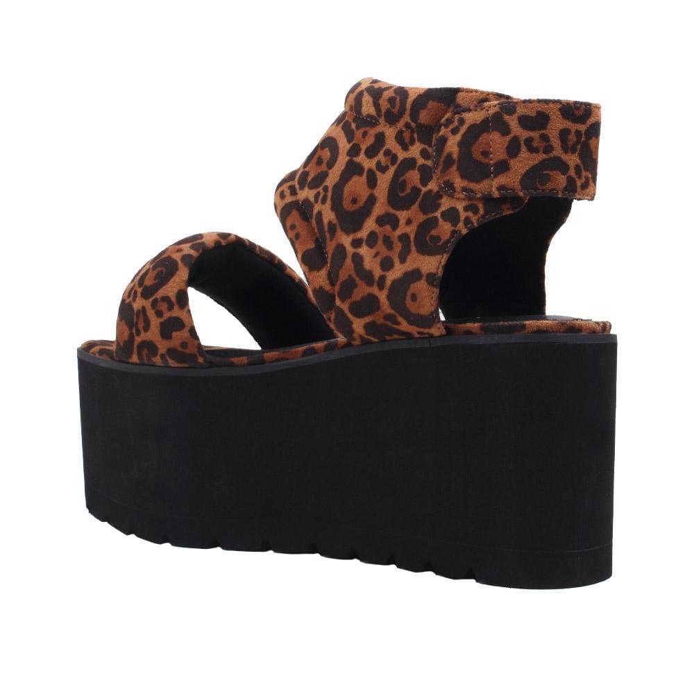 Women's platform shoes featuring tan-leopard design on the upper, velcro clasp, and a black sole-posterior view