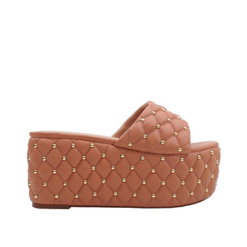 Women's tan-colored open-toed platform shoes with metallic studs and a slip-on design-side view