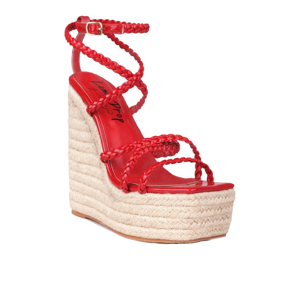 Women's tan wedge heels with crimson-colored upper strap and an ankle buckle clasp-corner view