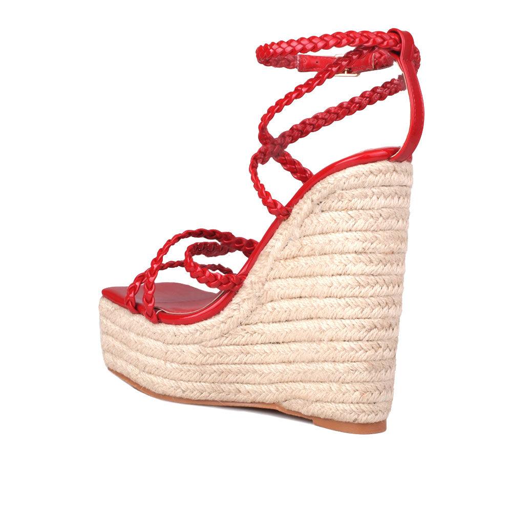 Women's tan wedge heels with crimson-colored upper strap and an ankle buckle clasp-posterior view