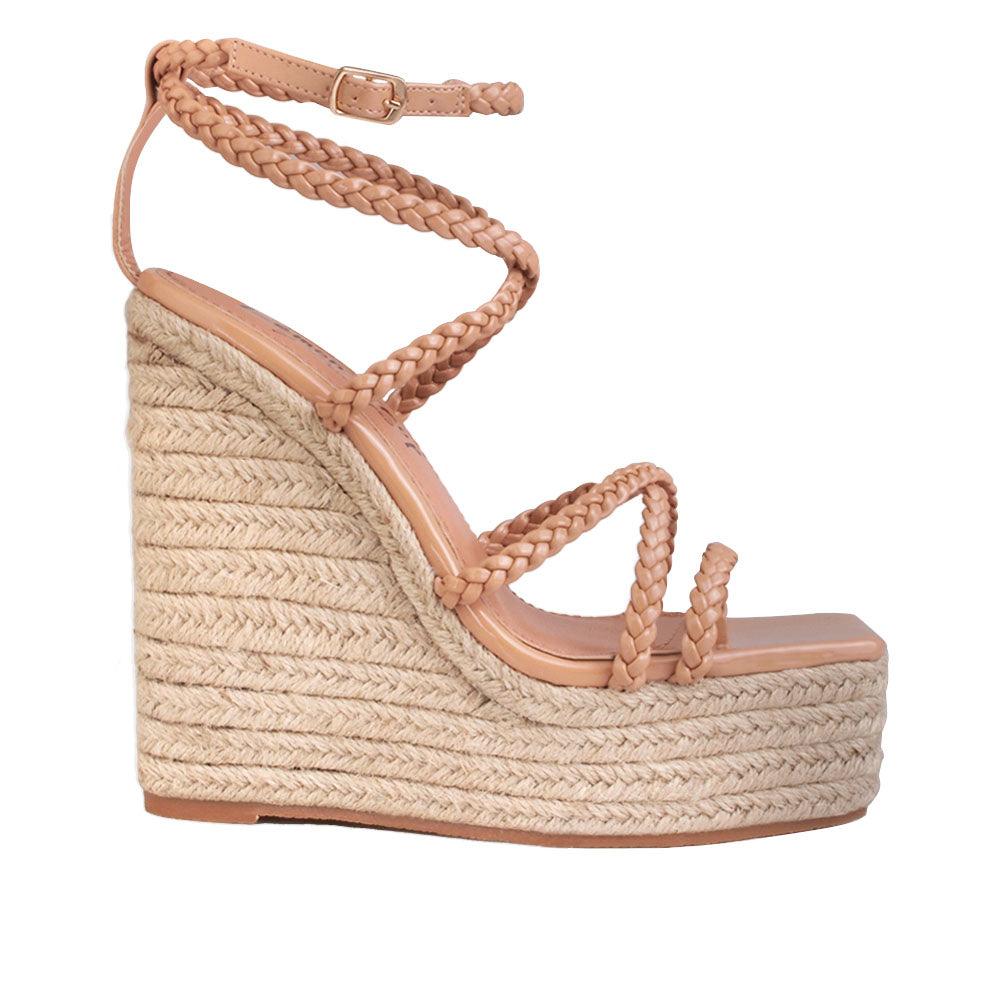 Tan wedge heels for women with a nude-colored upper strap and an ankle buckle clasp-side view