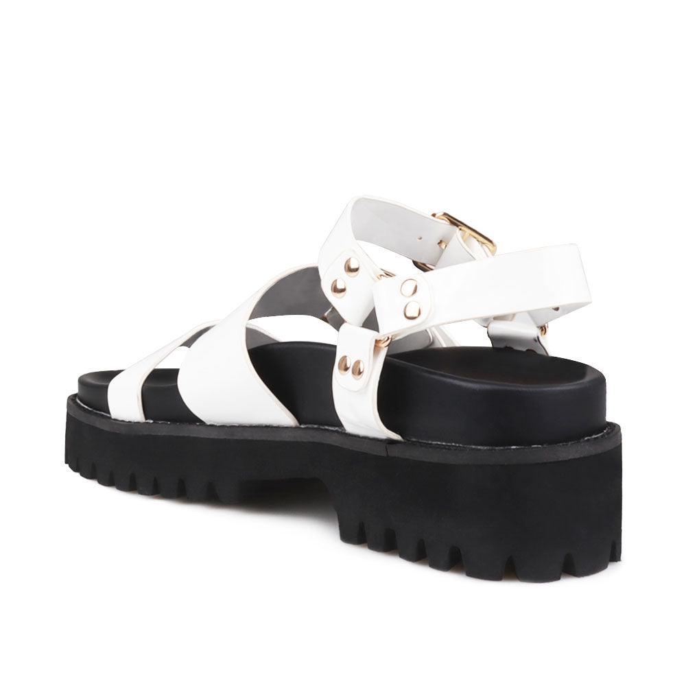 Women's white platform with buckle straps, ankle buckle closure, and black bottom-posterior view