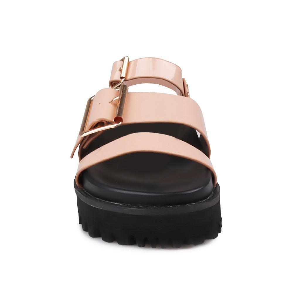 Nude-colored women's platform sandals with ankle buckle closure and buckle strap design upper-front view