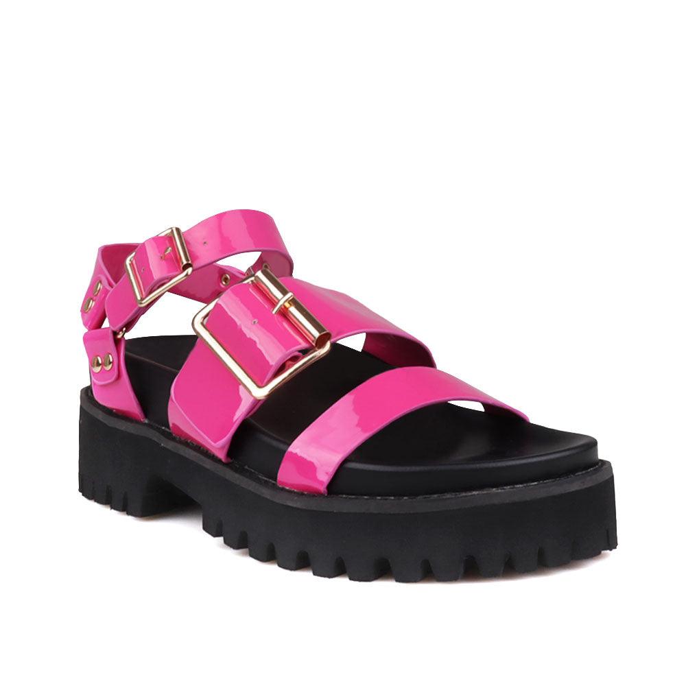 Fuchsia-colored women's platform with buckle straps, ankle buckle fastening, and black bottom-corner view