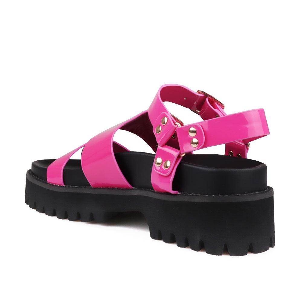 Fuchsia-colored women's platform with buckle straps, ankle buckle fastening, and black bottom-posterior view