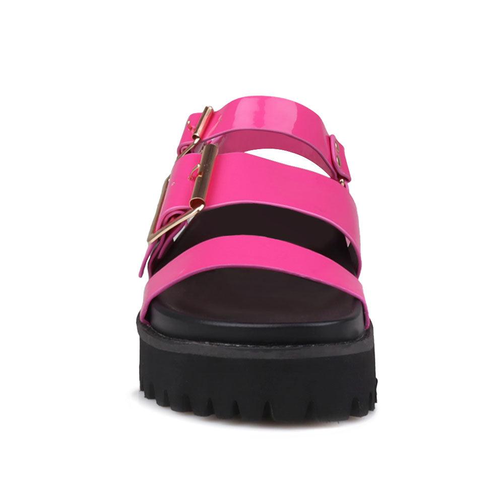 Fuchsia-colored women's platform with buckle straps, ankle buckle fastening, and black bottom-front view