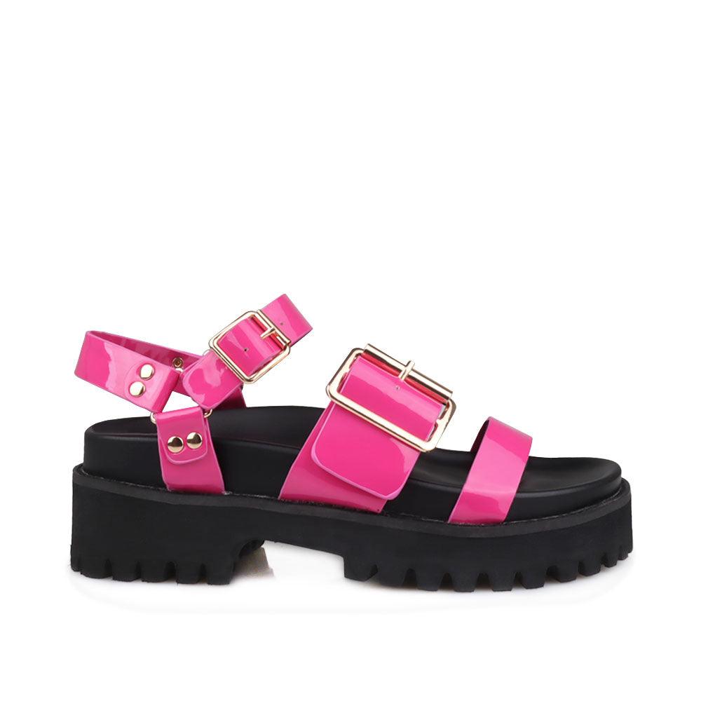 Fuchsia-colored women's platform with buckle straps, ankle buckle fastening, and black bottom-side view