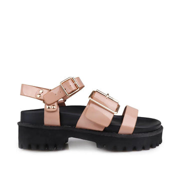 Nude-colored women's platform sandals with ankle buckle closure and buckle strap design upper-side view
