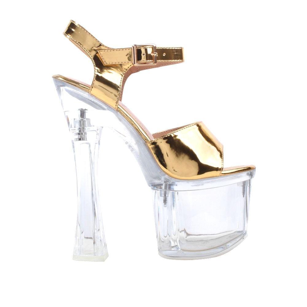 Ladies' clear platform heels with golden-colored top and ankle buckle clasp.