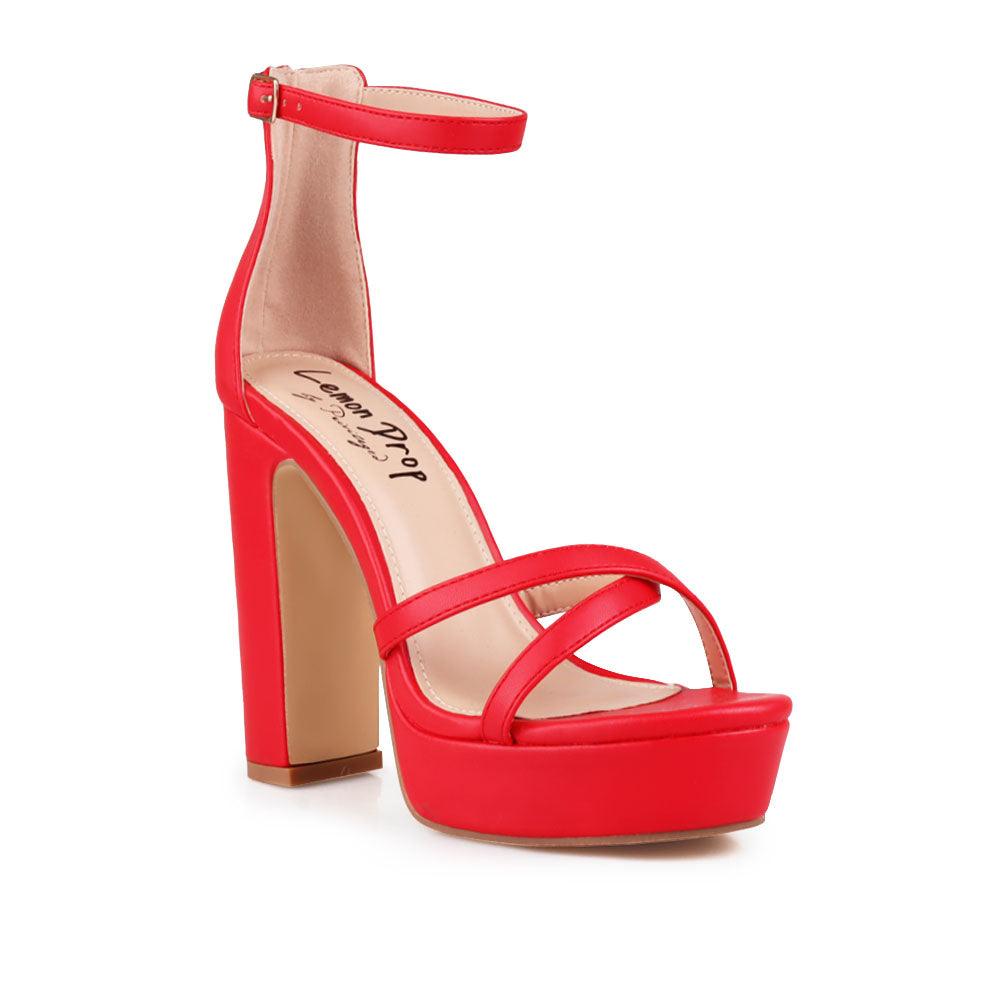 Red platform heels with ankle buckle closure and open toe design - corner view 