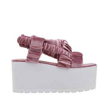 Baby pink women shoes with black colored platform-side view