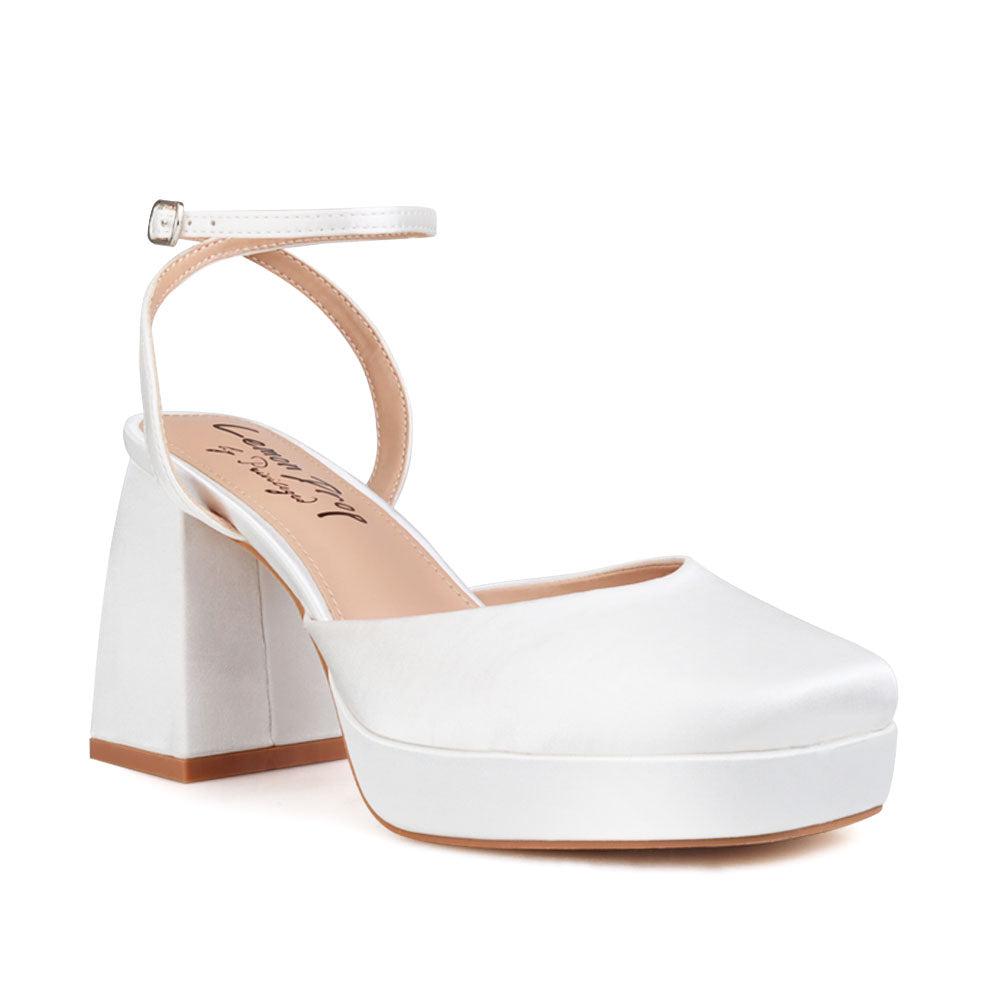 White women platforms with ankle buckle-corner view