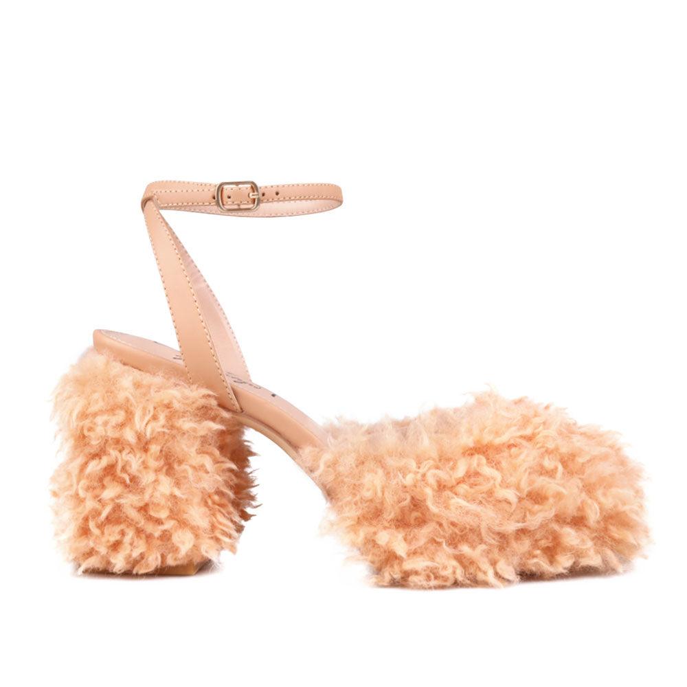 Nude colored women heel with vegan shearing upper-side view