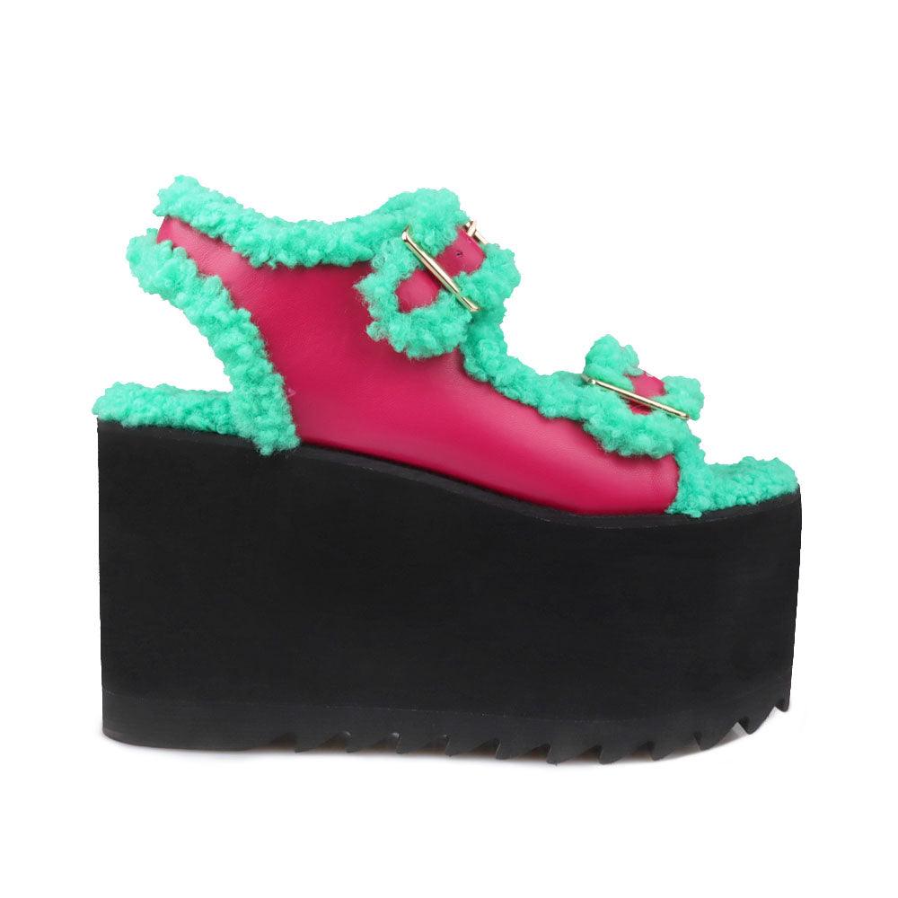 Black colored women platforms with green fur upper-side view