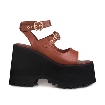 Brown women platforms with black bottom and double ankle buckles-side view