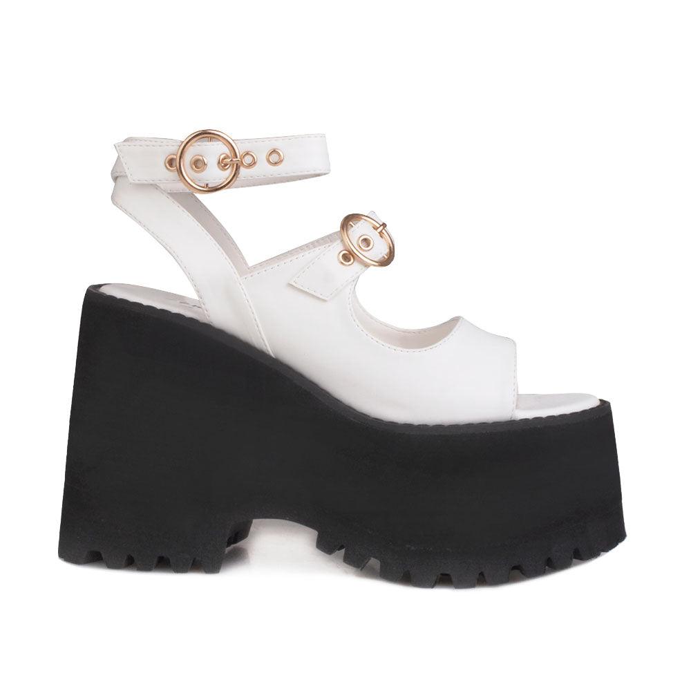 White women platforms with black bottom and double ankle buckles-side view