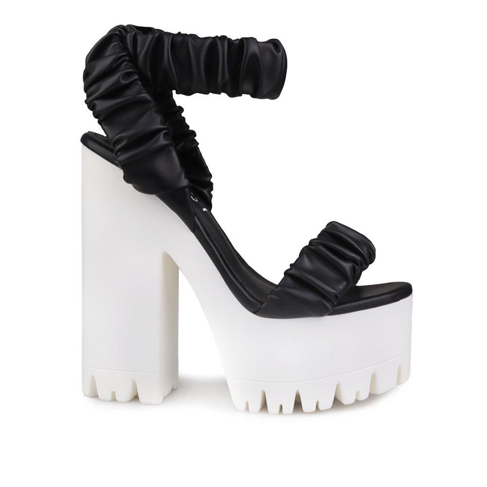 Women platform heels with velcro strap in black-side view