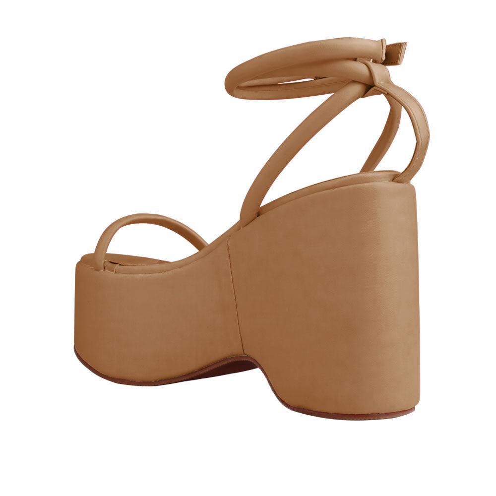 Nude colored women platforms with strappy ankle buckle closure-posterior view