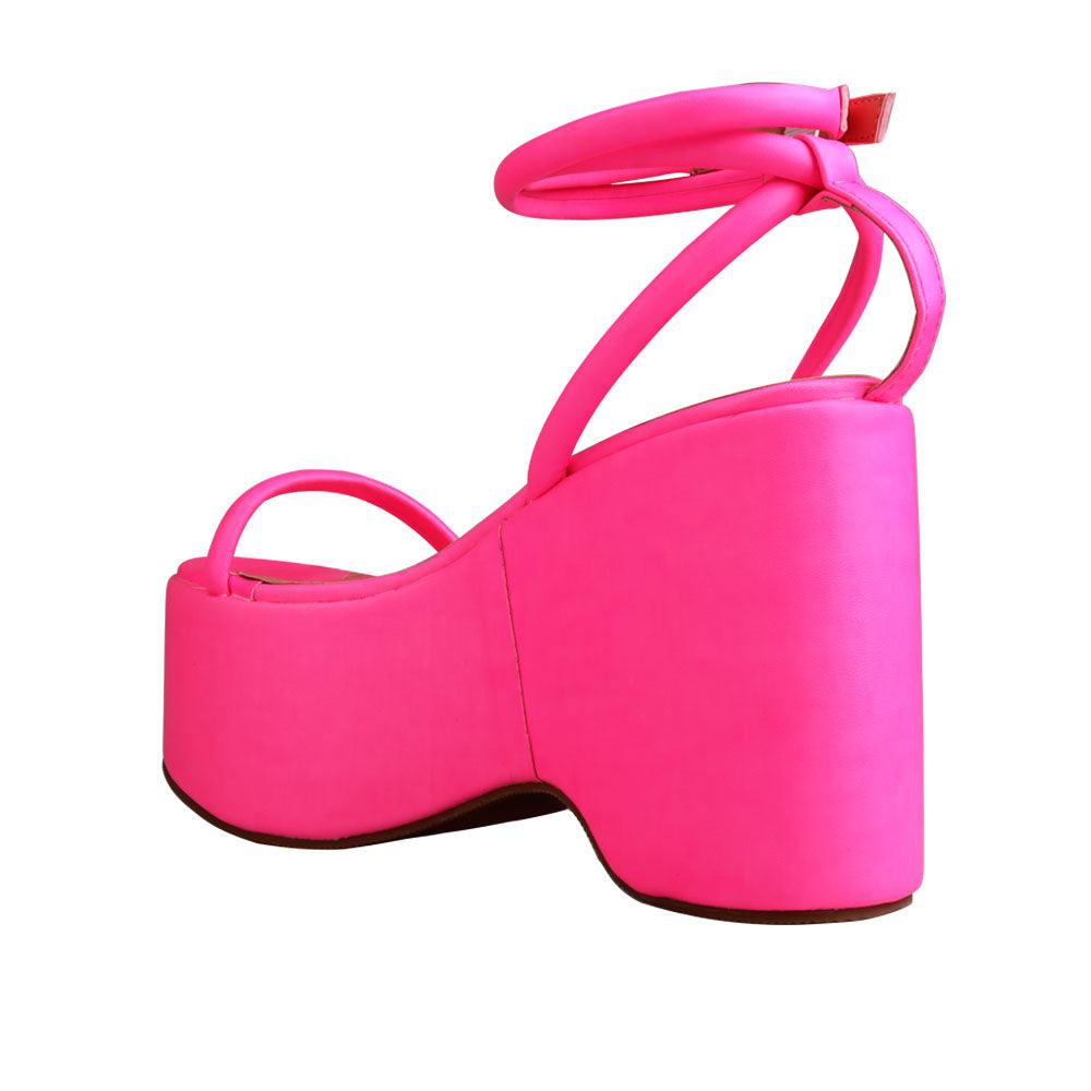 Pink colored women platforms with strappy ankle buckle closure-posterior view