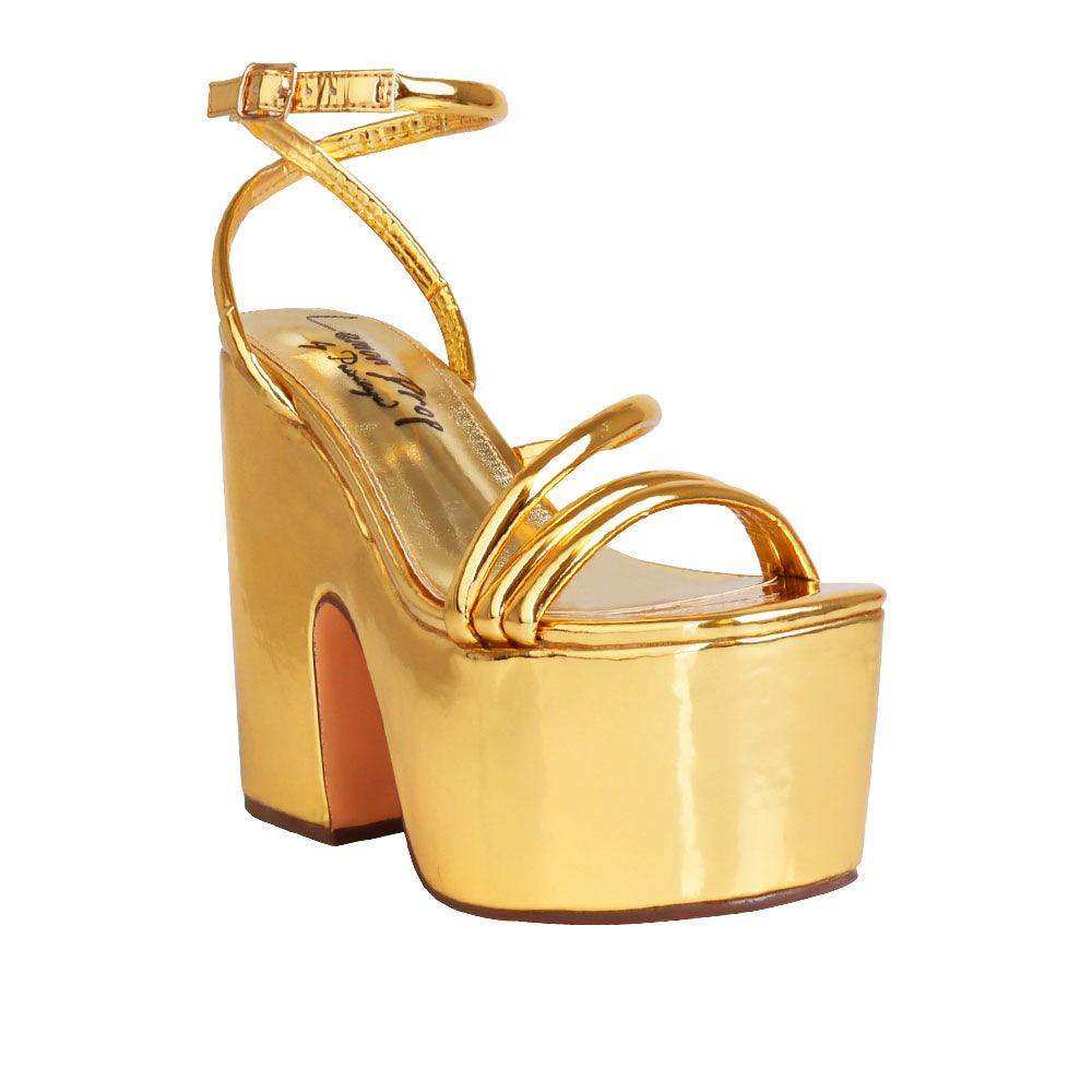 Golden colored women platform heels with ankle buckle closure-corner view