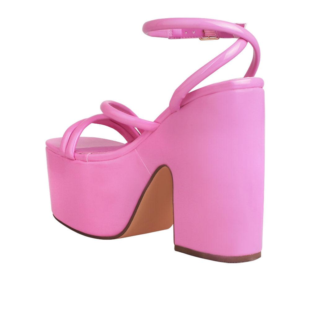 Pink colored women platform heels with ankle buckle closure-posterior view